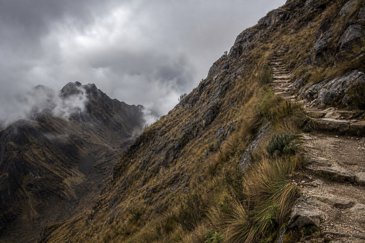 Hikers climbing the stone steps toward Dead Woman's Pass on the classic Inca Trail